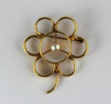 A gold brooch designed as a single flower head centred by a cultured pearl gross weight 28.4g