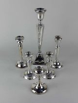 A George V silver candlestick, Chester 1917, 27cm high, a pair of George V silver candlesticks,