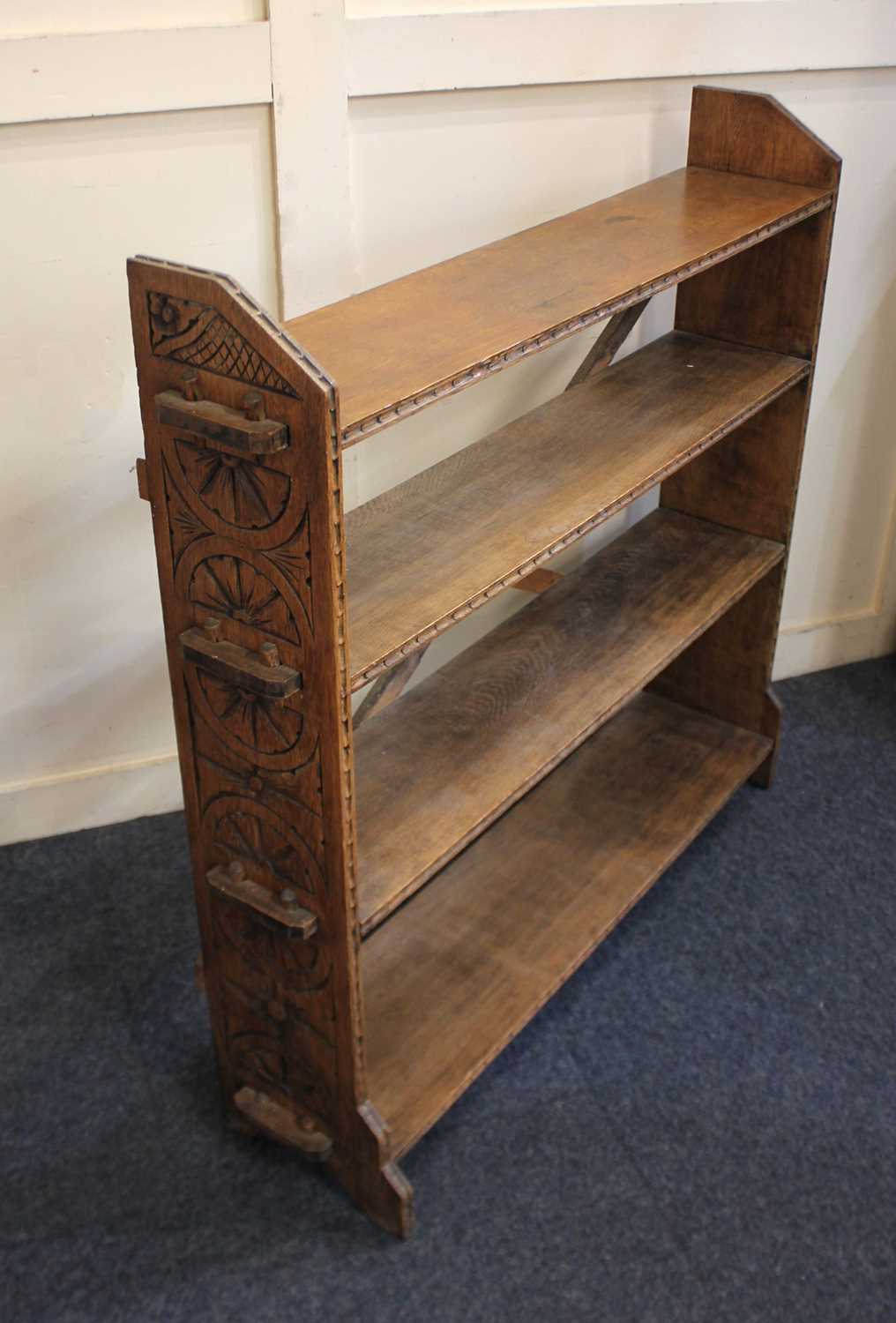 A carved oak open bookcase with four shelves and tenon tusk joints, 100cm