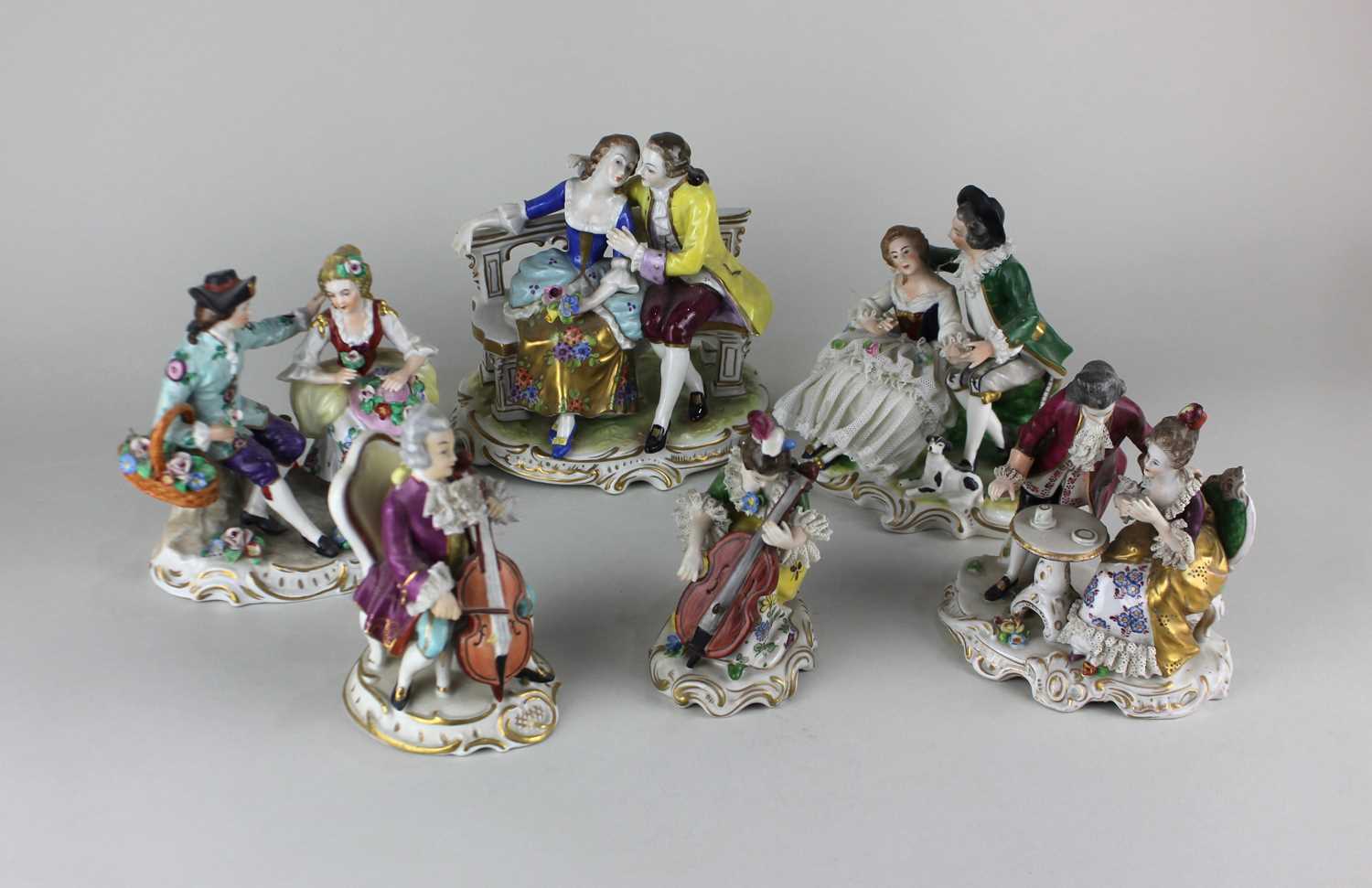 A Sitzendorf porcelain figure group of a courting couple holding flowers 13cm high, together with