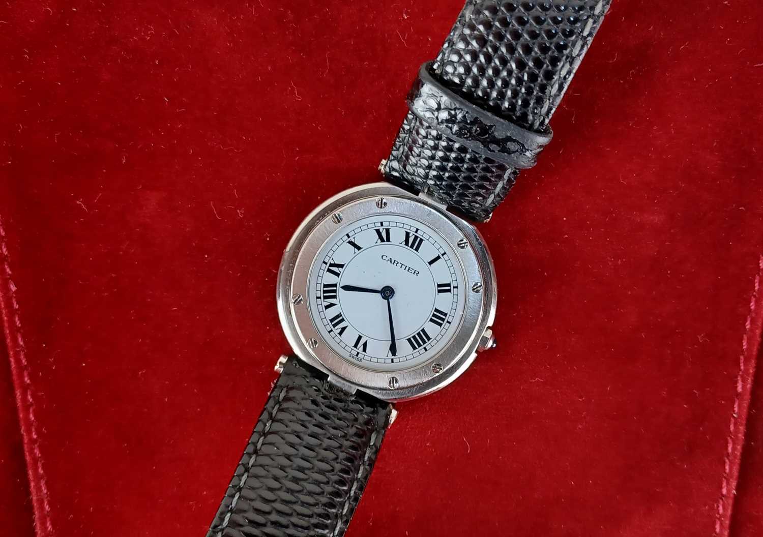 A Santos de Cartier quartz steel circular cased wristwatch, the signed white dial with black Roman