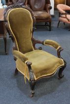 A Victorian carved walnut show-wood open sided armchair, with green fabric upholstered back, seat