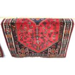 A Persian rug, red ground with central diamond-shaped medallion within a field of stylised