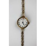A 9ct gold circular cased lady's bracelet wristwatch, the enamelled dial with Roman numerals, on a