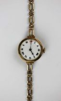 A 9ct gold circular cased lady's bracelet wristwatch, the enamelled dial with Roman numerals, on a