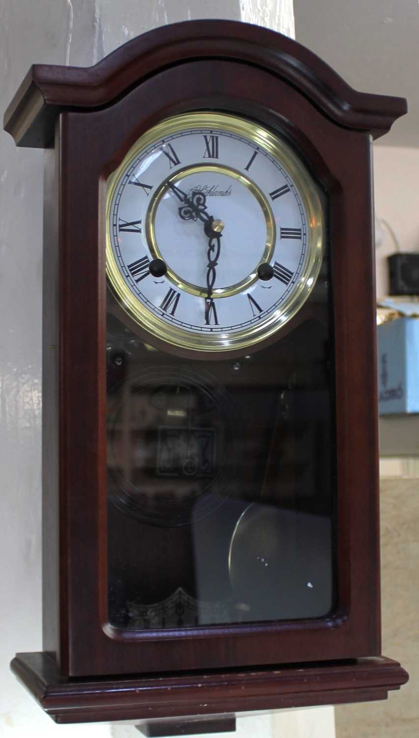 A mahogany cased wall clock with Westminster chimes, circular dial marked 'Highlands' 45cm high