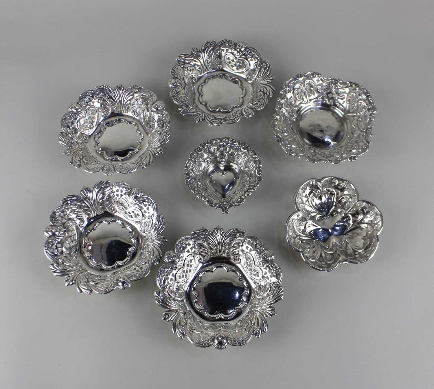 A set of four Victorian silver bonbon dishes pressed and pierced design with foliate and angel