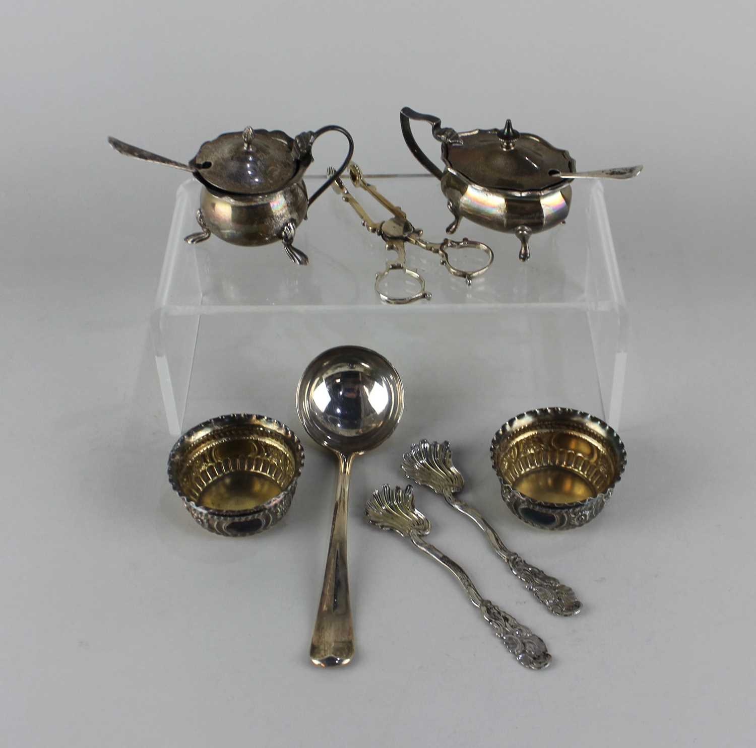 A pair of Victorian silver salt cruet dishes London 1897, a pair of George V silver sugar nips,