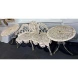 A white painted metal three seater garden seat the arched back with foliate and scroll medallion