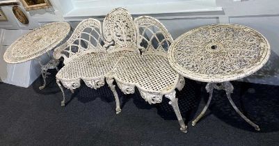 A white painted metal three seater garden seat the arched back with foliate and scroll medallion