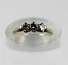 A gold and diamond three stone ring, claw set with a row of circular cut diamonds, detailed '520',