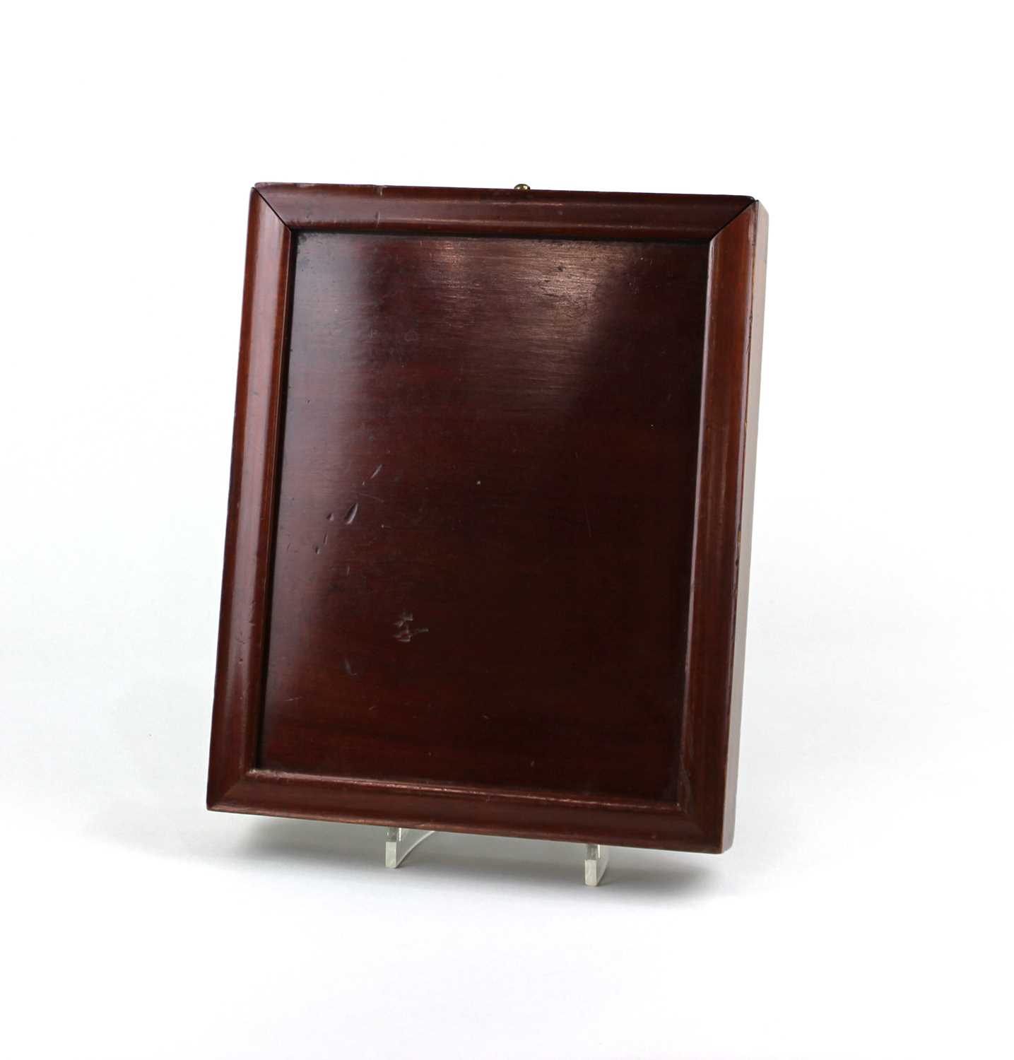 A 19th century mahogany campaign mirror with slide out cover, rear stand and brass hanging loop