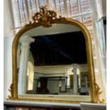 A giltwood and gesso arched over mantle mirror with shell and scroll surmount (a/f), ht. 123cm w.136