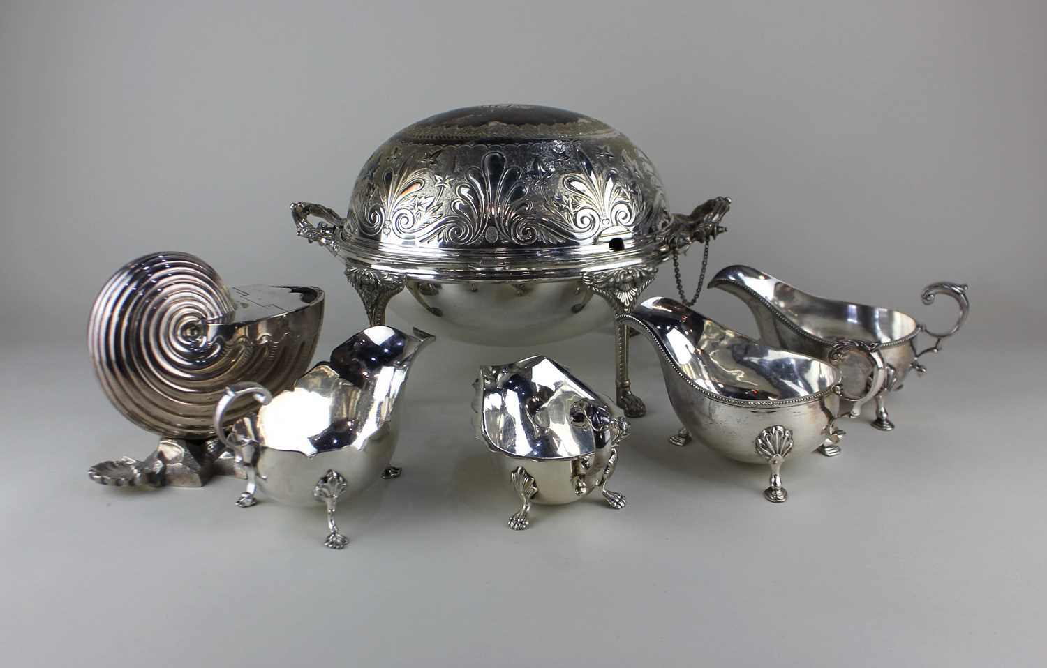A Victorian silver plated nautilus shell spoon warmer four sauce boats and an oval breakfast