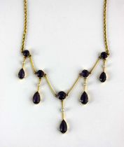 A gold, amethyst and seed pearl necklace, the front mounted with a row of five graduated cushion