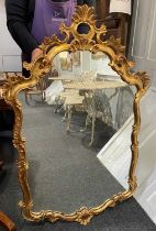 A Louis XV style giltwood cartouche shaped wall mirror, with pierced scrolling foliate decorated