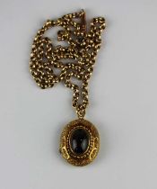 A Victorian carbuncle garnet oval pendant locket fitted to a gold circular link neckchain
