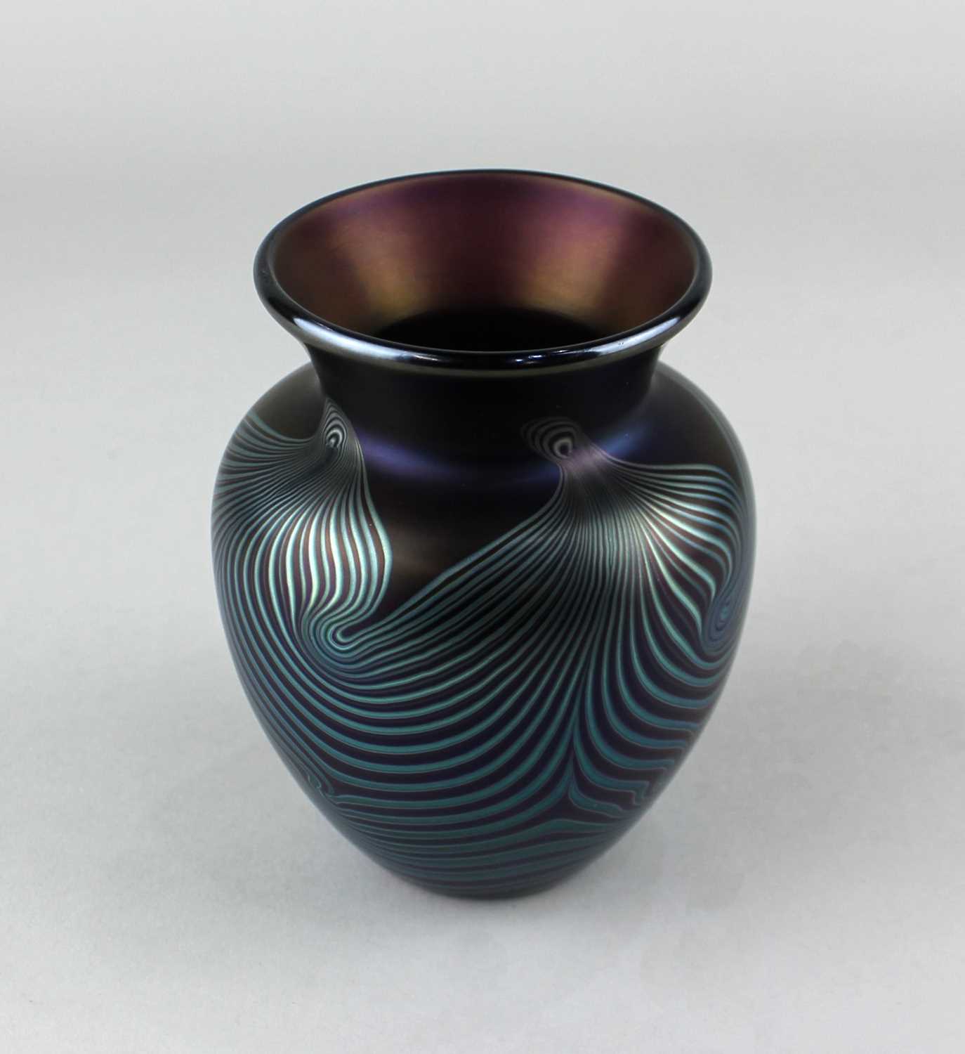 An Okra iridescent glass vase with swirled design, the base engraved 'Okra Glass Guild Founder