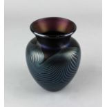 An Okra iridescent glass vase with swirled design, the base engraved 'Okra Glass Guild Founder