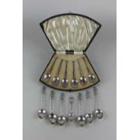 A cased set of six George V silver coffee spoons Sheffield 1929, six Chinese metal spoons and a