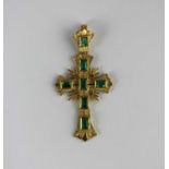 A gold and emerald pendant cross mounted with seven rectangular cut emeralds, detailed '18k',