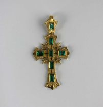 A gold and emerald pendant cross mounted with seven rectangular cut emeralds, detailed '18k',