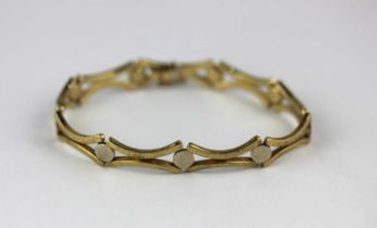 A 9ct two colour gold bracelet in a twin curved bar and circular link design on a snap clasp,