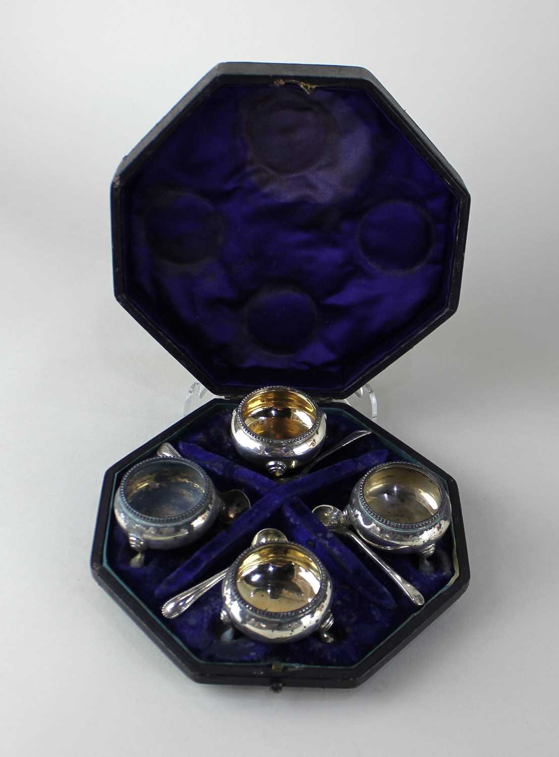 A cased set of four Victorian silver salt cruets circular cauldron form with beaded rims and three