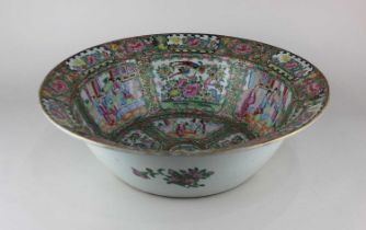 A large Chinese Cantonese porcelain bowl decorated with panels of figures and birds and insects