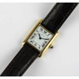 A Cartier Paris gold rectangular cased Tank wristwatch the signed white dial with black Roman