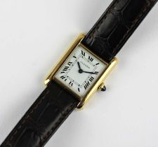 A Cartier Paris gold rectangular cased Tank wristwatch the signed white dial with black Roman