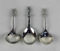 A Victorian silver apostle tea caddy spoon maker William Edwards, London 1876 and a pair of later