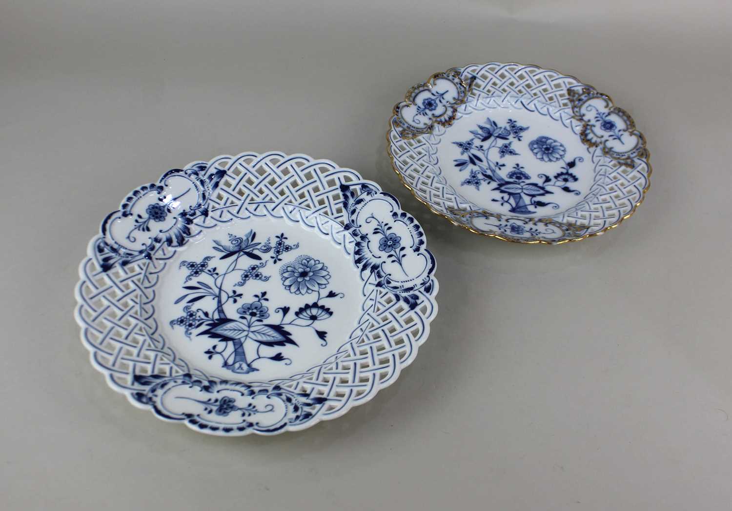 Two similar Meissen porcelain plates each with pierced woven border and blue floral design on