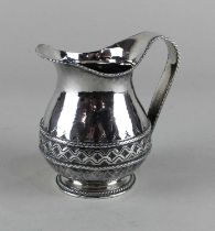 A Liberty & Co. George V silver cream jug with central decorative band, hallmarked Birmingham