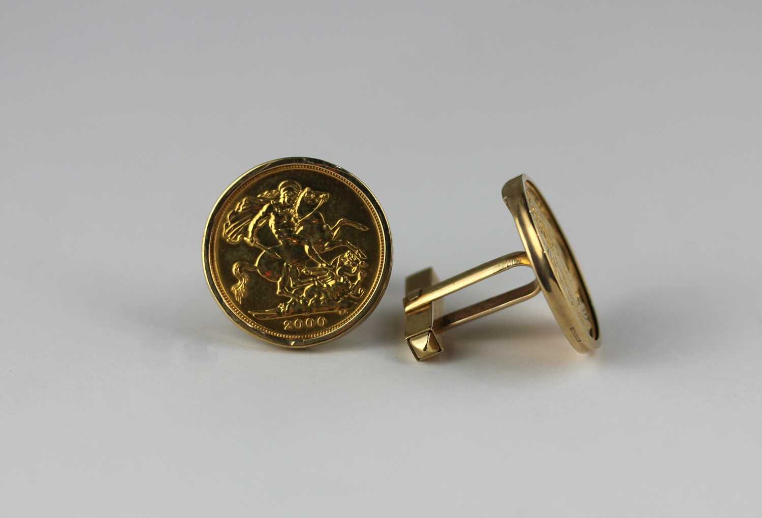 A pair of gold mounted sovereign cufflinks the sovereigns 1997 and 2000, with a case, combined gross