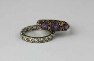 A 9ct gold amethyst and colourless gemset ring mounted with three circular cut amethysts,