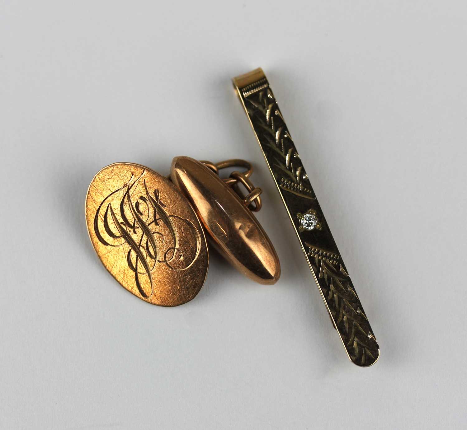 A 9ct gold and diamond set tie slide, Birmingham 1985, and one 9ct gold cufflink, combined gross