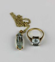 A gold and aquamarine single stone pendant claw set with an oval cut aquamarine, with a gold neck