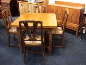 An oak draw leaf dining table on four carved legs with uniting X frame stretcher 153cm fully
