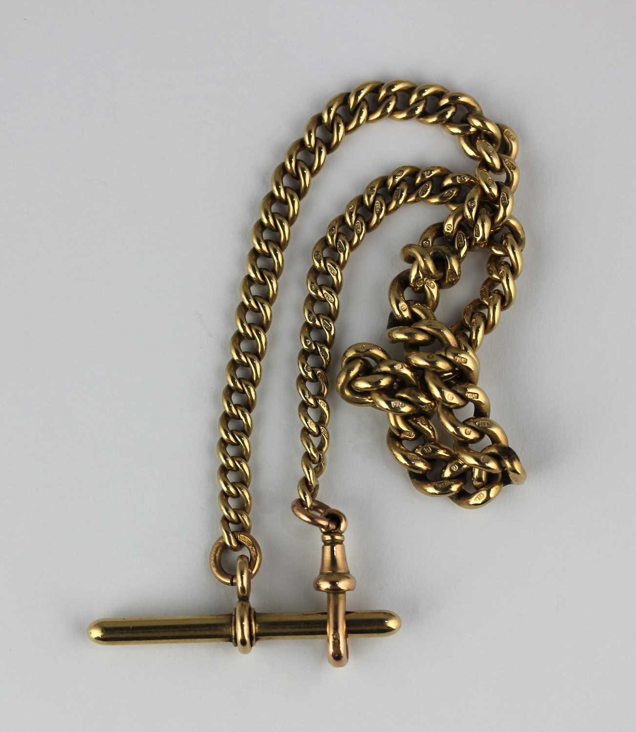 A 9ct gold graduated curb link watch Albert chain fitted with a 9ct gold T bar and with a 9ct gold