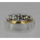 A gold and diamond five stone ring claw set with a row of graduated cushion shaped diamonds, the