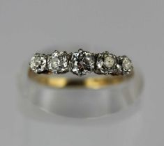 A gold and diamond five stone ring claw set with a row of graduated cushion shaped diamonds, the