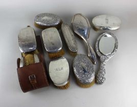Four pairs of early 20th century silver backed hair brushes of various design (a/f brushes worn),