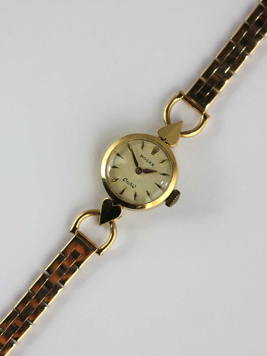 A Rolex Orchid gold circular cased lady's wristwatch, the signed silvered dial with gilt baton