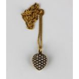 A gold and seed pearl heart shaped pendant c1910, fitted to a later 9ct gold faceted curb link