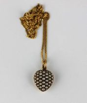 A gold and seed pearl heart shaped pendant c1910, fitted to a later 9ct gold faceted curb link