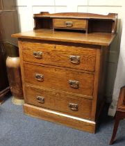 An early 20th century Arts and Crafts oak chest of drawers, raised gallery back with small drawer