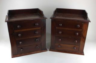 A pair of Victorian mahogany apprentice chests, each having a three-quarter gallery top above 4