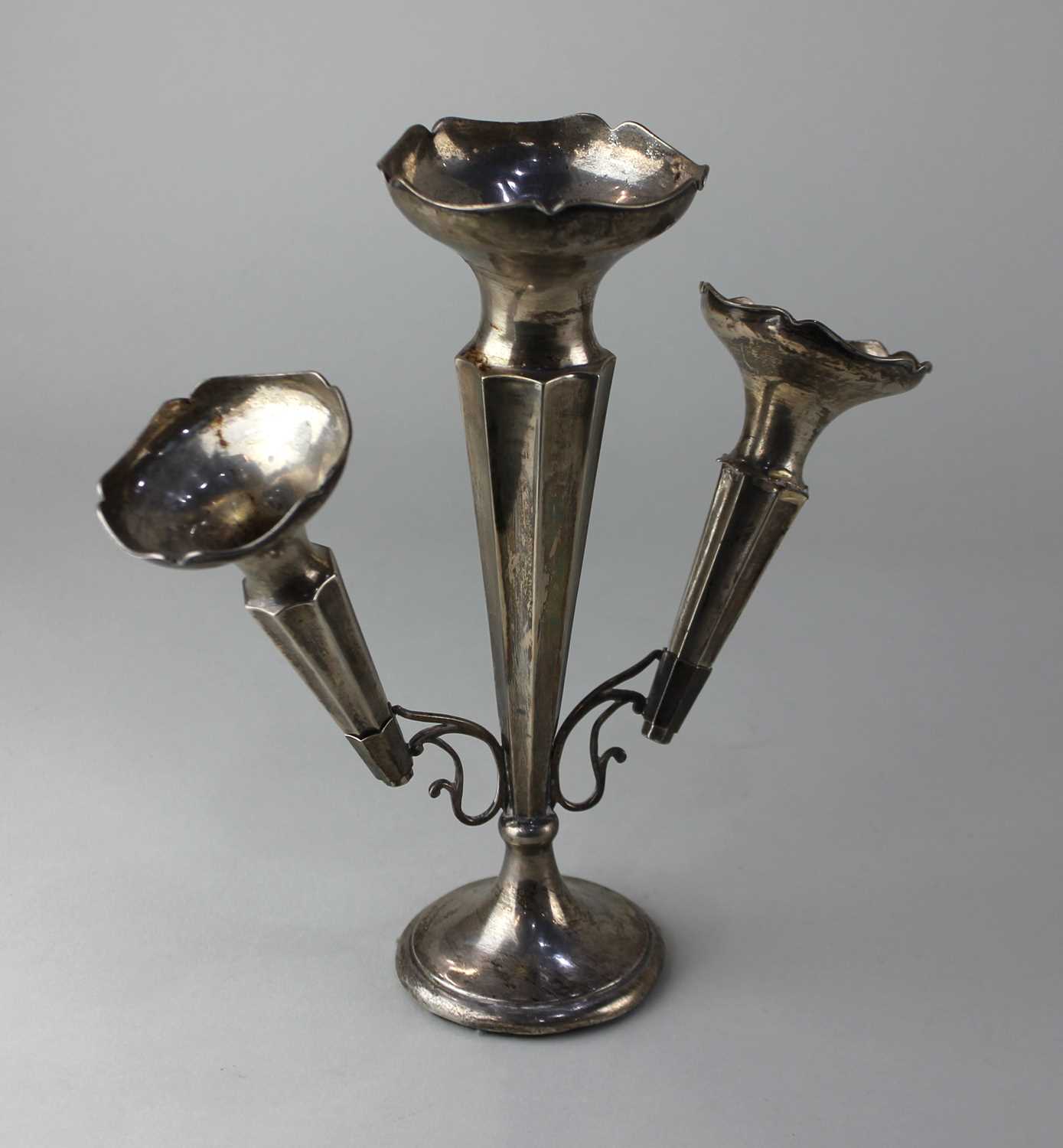 A George V silver epergne with central tapered vase and two detachable vases on loaded circular