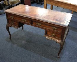 A late 19th century walnut desk in the French Hepplewhite taste, having an inset leather top above